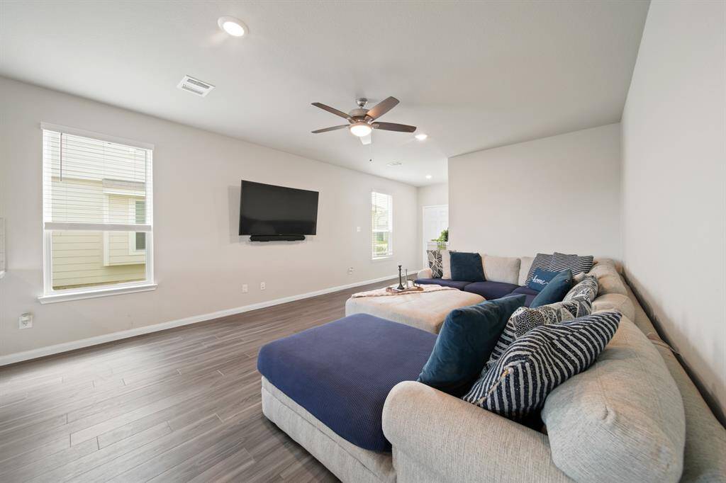 Another view of the large family room (TV included). There are so many furniture configuration possibilities in tis space. And look at the incredible natural light from the large windows featuring cordless blinds.