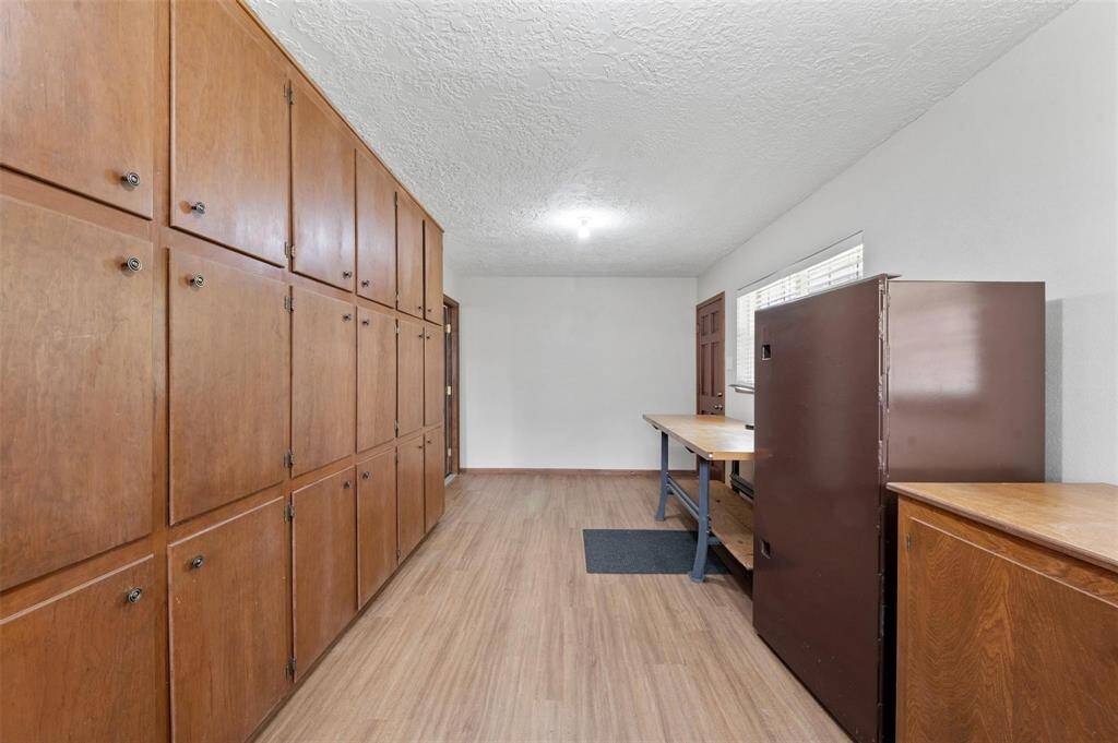 The air-conditioned workshop, located behind the garage, comes furnished with tons of storage, work tables, and a gun safe.