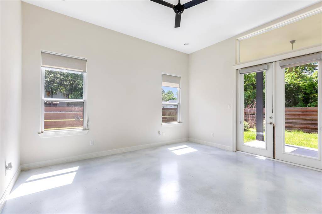 Master bedroom with access to covered back patio. High ceilings, recessed lighting and stained concrete floors