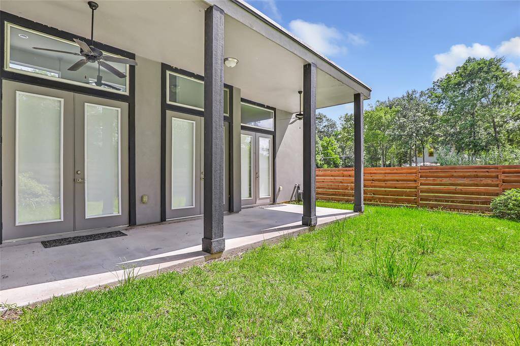 Covered back patio with fenced in portion of yard. (Lot size is over 1 acre)