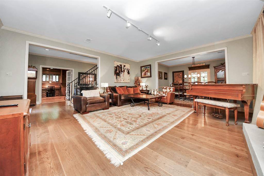 A sizable den invites the family to congregate—offering plenty of space for relaxing, entertaining, and making memories together.