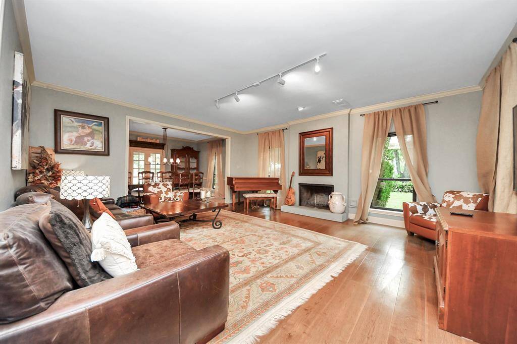 Another view of this perfect den highlights its spacious comfort and reveals the convenient proximity of the dining room—ideal for celebrations, holidays, and everyday gatherings.