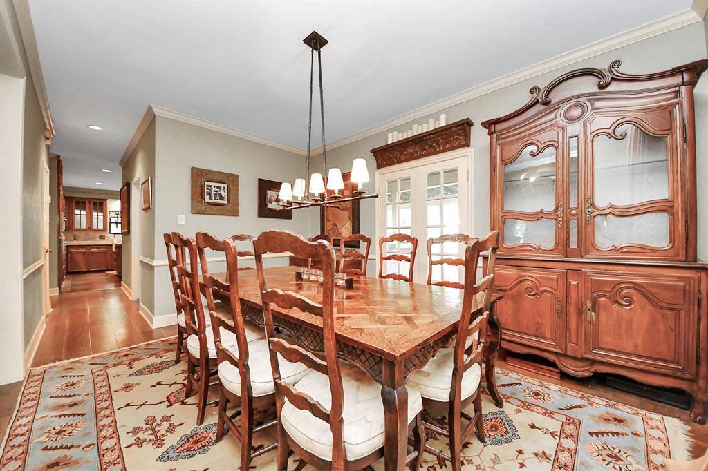 A dining room worthy of holiday feasts and unforgettable gatherings, this space easily holds a large banquet table for evenings to remember. French doors open to the backyard, while just down the corridor, the kitchen offers convenient access for seamless entertaining.