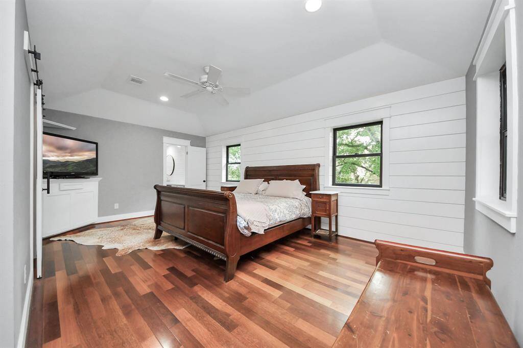 The luxurious primary suite offers generous space, rich Brazilian Cherry floors, and a charming shiplap accent wall—creating a warm, elegant retreat.All bedrooms are located upstairs, providing privacy and a defined separation between living and sleeping areas.