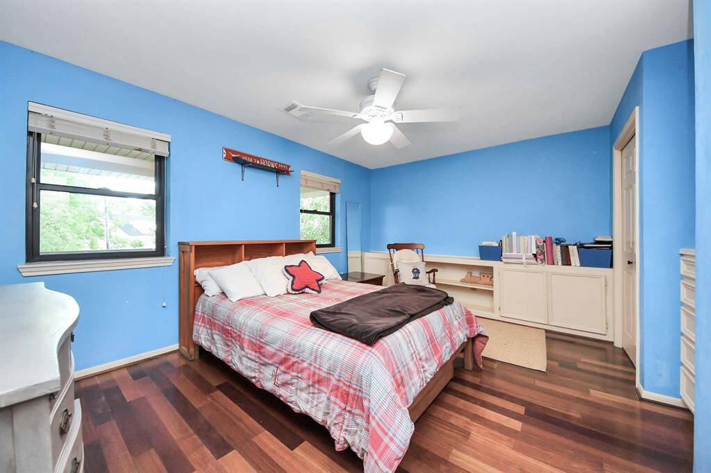 One of three secondary bedrooms. Brazilian Cherry floors continue throughout the upstairs bedrooms. Each bedroom is generously sized, offering plenty of room for creating a personal haven.