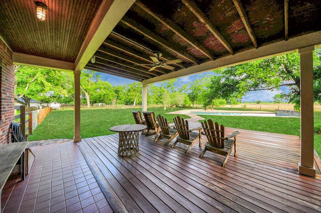 Step outside to a covered patio offering endless room to relax or entertain—all overlooking a lagoon-like, resort-worthy pool that invites you to dive right into summer.