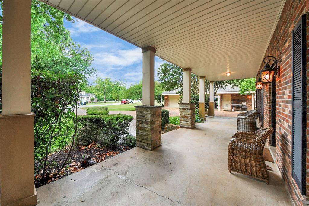 From this angle, the length of the porch truly shines—ideal for rocking chairs, morning coffee, or watching the horizon over the quiet countryside. Southern hospitality starts right here.