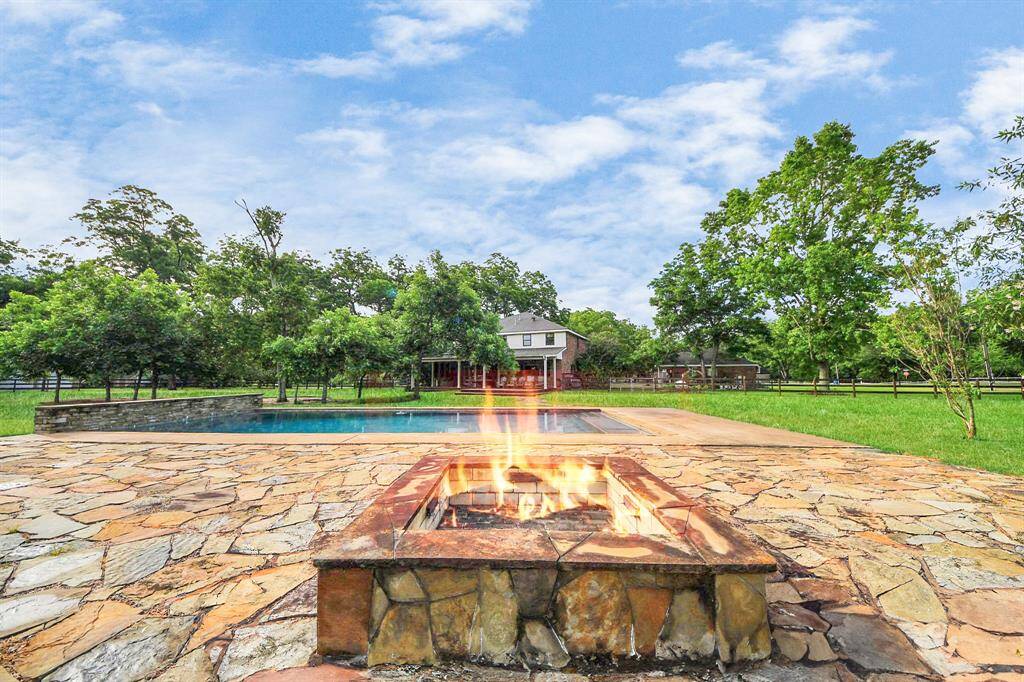 A custom fire pit creates the perfect gathering spot for cool evenings—ideal for making s’mores or grilling over the grate while enjoying the serenity.