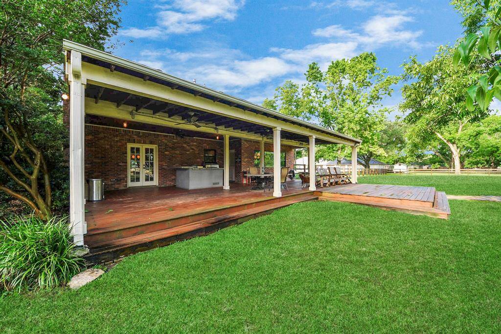 Another view of the spacious back patio - Full gutters around the home ensure effective rainwater management, protecting both the house and surrounding landscaping.