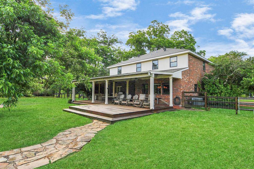An enchanting flagstone path guides you from the back of the home to the sparkling pool area.