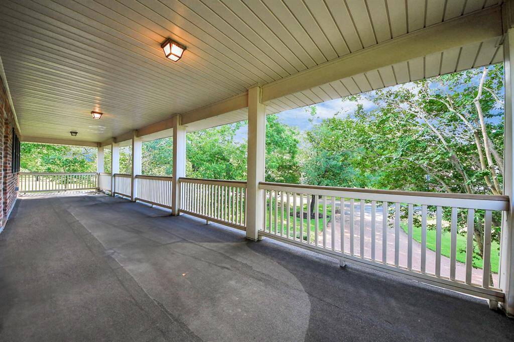 Moving to the front of the home, a covered balcony on the upper level offers a delightful spot to relax while overlooking the beautifully landscaped front yard.