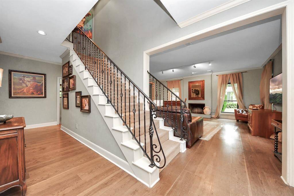 This generous entryway offers a warm welcome with its open feel and thoughtful details—like the seagrass runner lining the staircase, a stylish and practical touch that elevates the space.