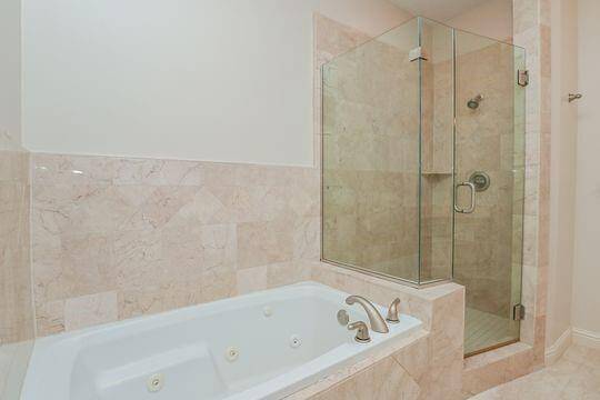 The primary bath has a stand alone shower & a separate garden tub.