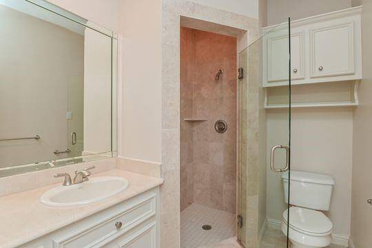 Marble, stone & travertine combine for a lovely 2nd bedroom bath.