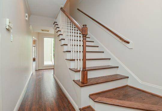 Wide wooden stairs lead to the 3rd floor.