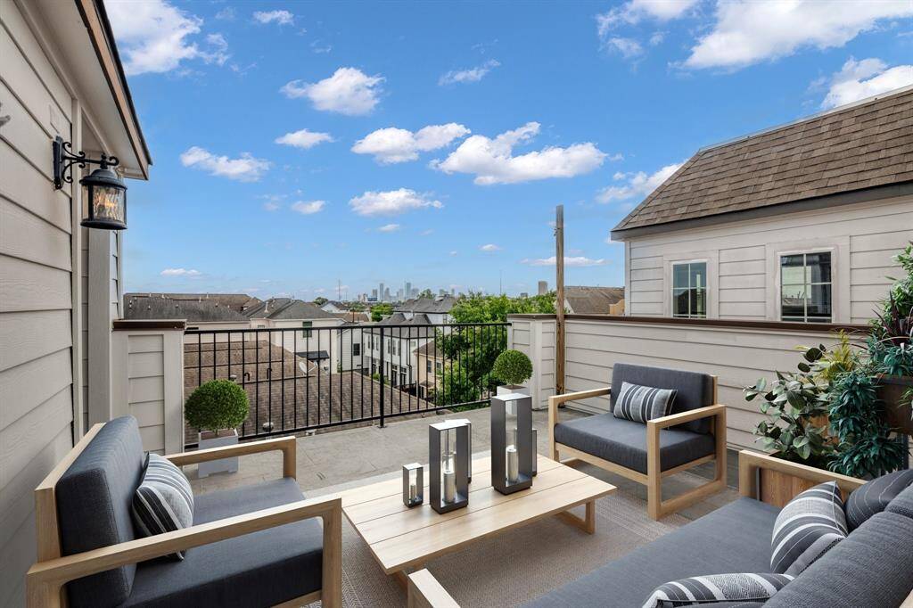 Virtually Staged: Spacious rooftop terrace with a tiled floor, offering a clear view of the Houston Downtown skyline. High above other properties it provides a private and scenic outdoor space.