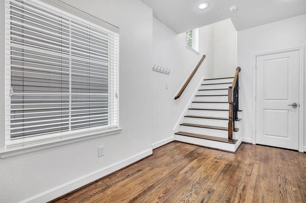 Staircase leading you upstairs, storage space under the stairs.
