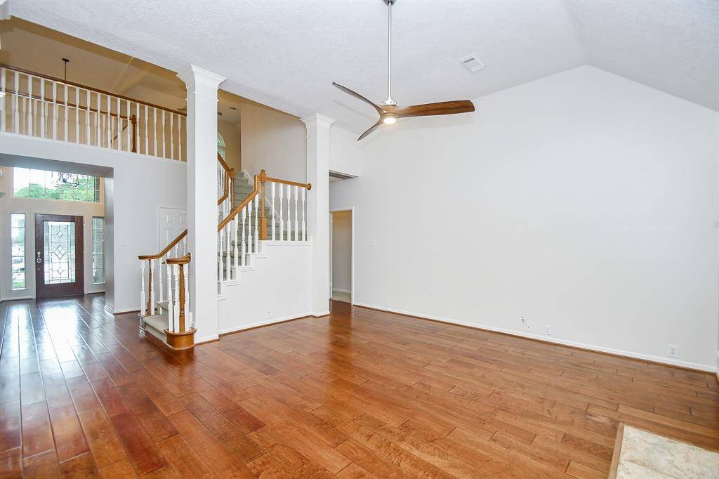 Family Room boasts a high ceiling and Wood Floors