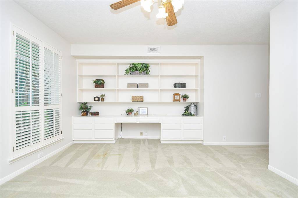 A large 1st floor Study on the 1st floor with a custom built-in desk with shelves!
