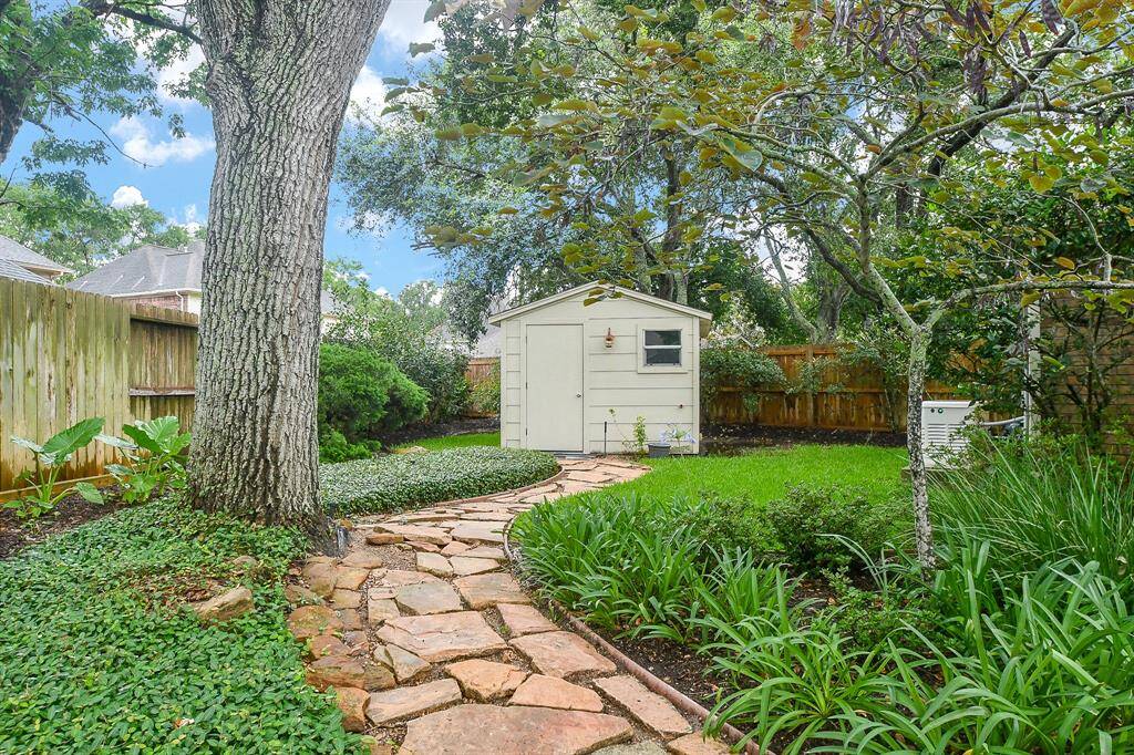A Large Storage Shed tucked away behind the Garage!