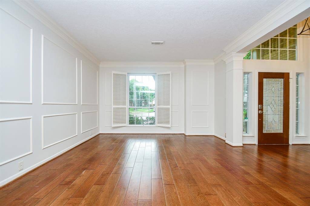 Huge Formal Living Room/ Dining Room with gorgeous wood floors!
