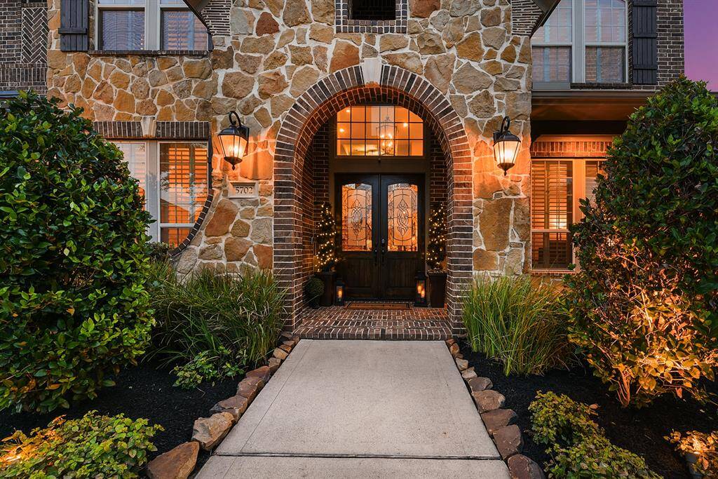 A grand front entry welcomes you with stunning double doors and a charming front porch.