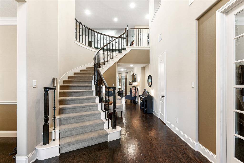 A grand winding staircase with soaring ceilings greets you and your guests.