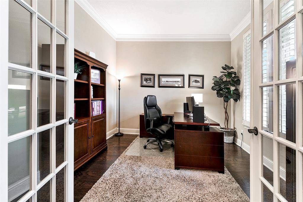 Private study with French doors, wood floors, and crown molding.