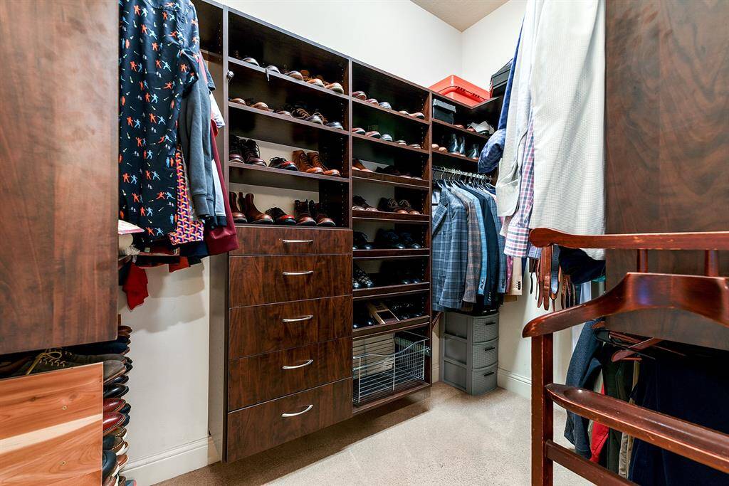His-and-her custom closets offer generous storage with built-in organization.