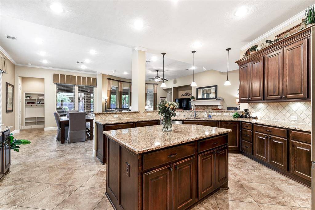 Gourmet kitchen includes working island, granite counter tops, 42 inch cabinets with hardware, pendant lighting, stainless steel appliances and so much more!