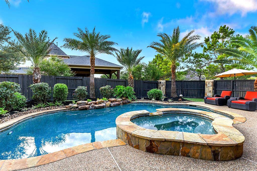 The pool has a hot tub and a waterfall feature.  The landscaping out back has been well maintained.
