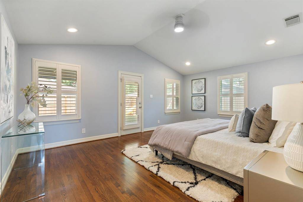 The spacious primary retreat features vaulted ceilings, direct patio access, and a stunning en-suite bath