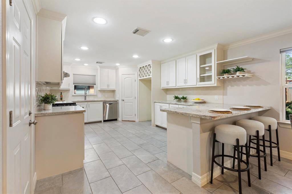 The stunning kitchen is filled with natural light