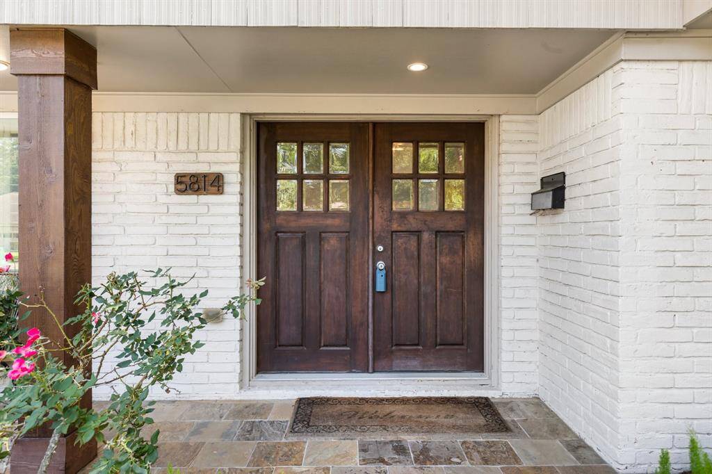 Custom Craftsman double entry doors provide a warm invitation inside.