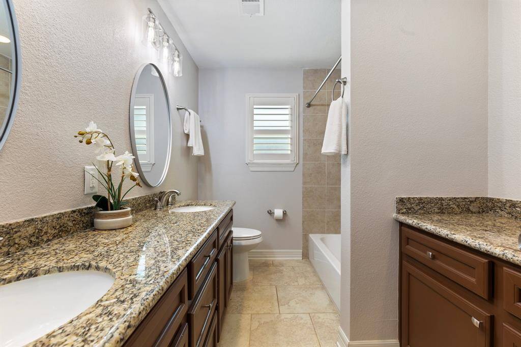 The second bath offers a double vanity with extra storage and counter