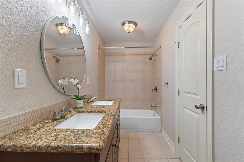 The third bathroom includes a double vanity as well