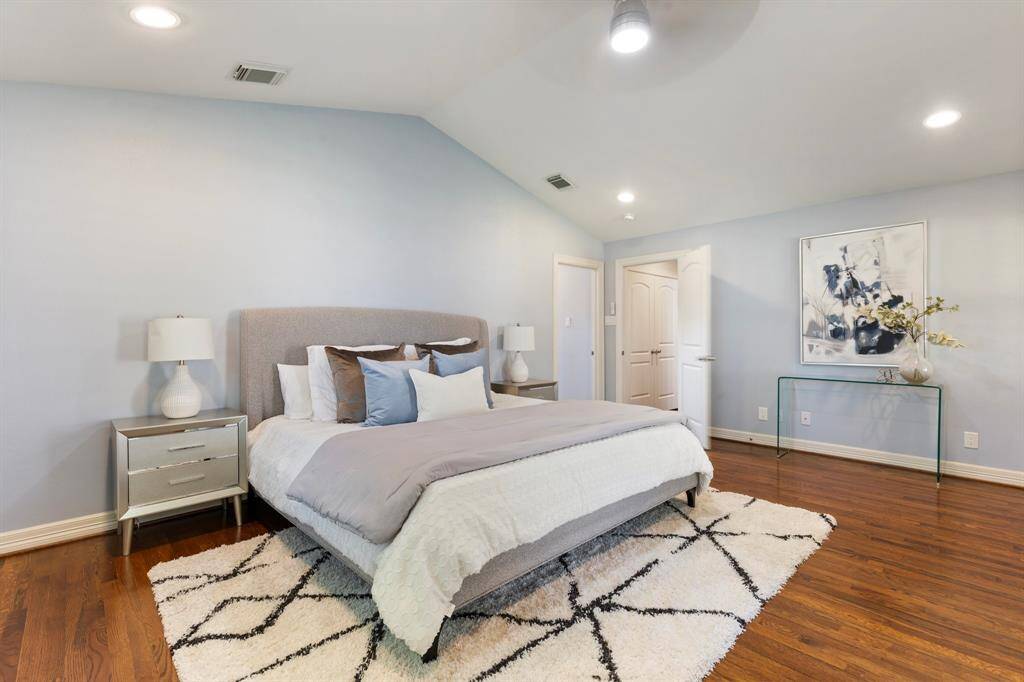 The spacious primary retreat features vaulted ceilings, direct patio access, and a stunning en-suite bath
