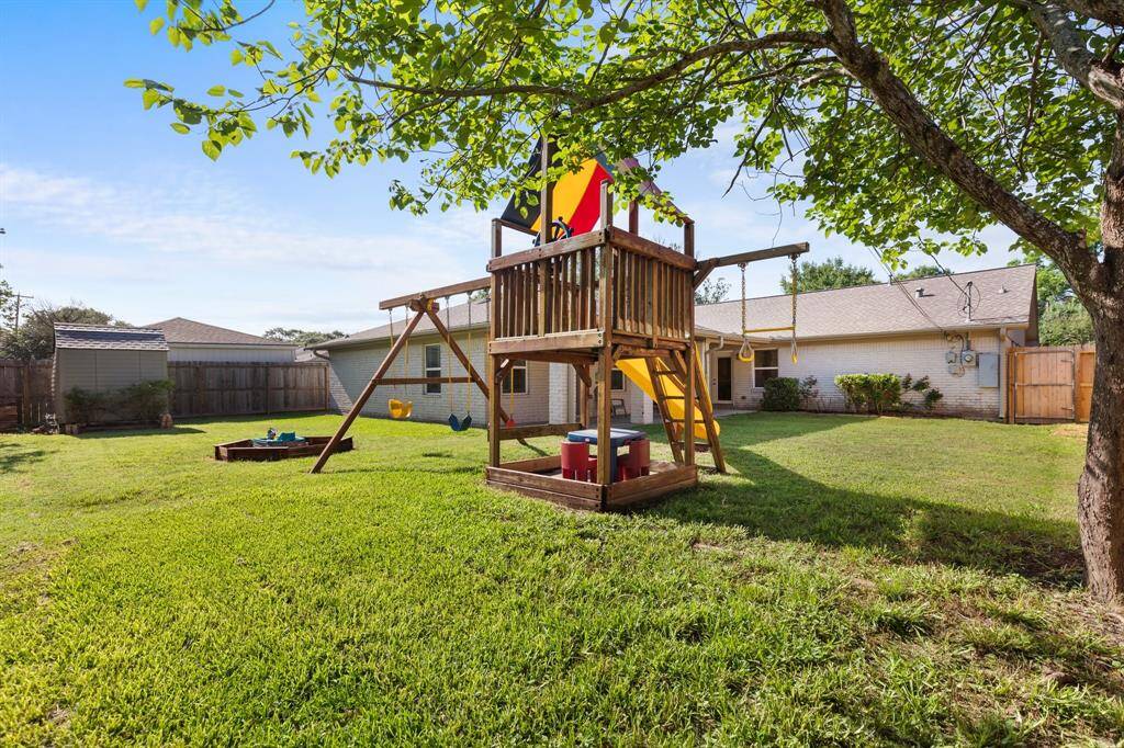 The oversized backyard has room for a pool, and includes this amazing play structure, sand pit, and storage shed