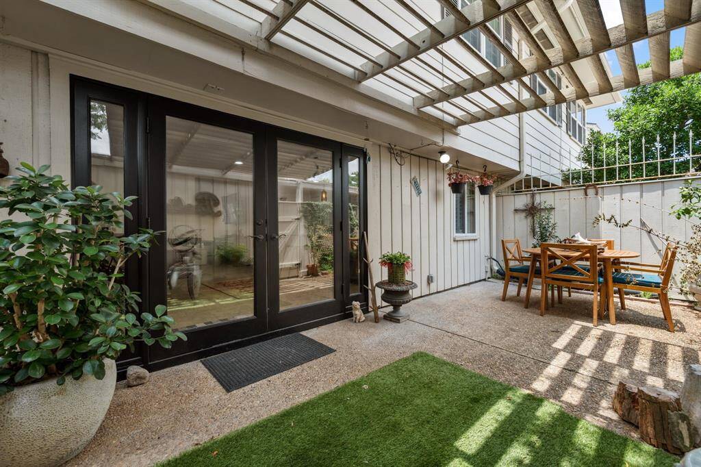 Condo has a one car garage and one car covered parking area attached to patio area.