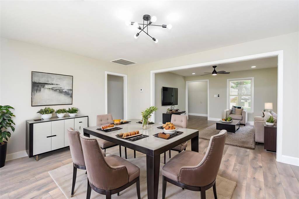 The gorgeous lighting fixture hangs above the dining room, giving a modern touch to the home.