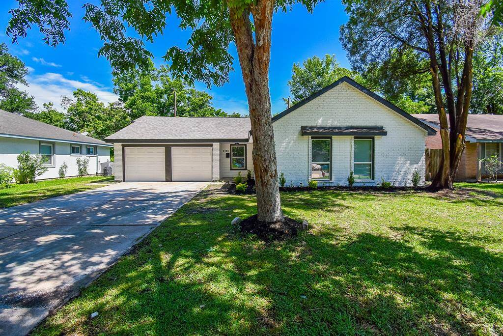 The long driveway leads to the two-car garage, allowing ample parking.