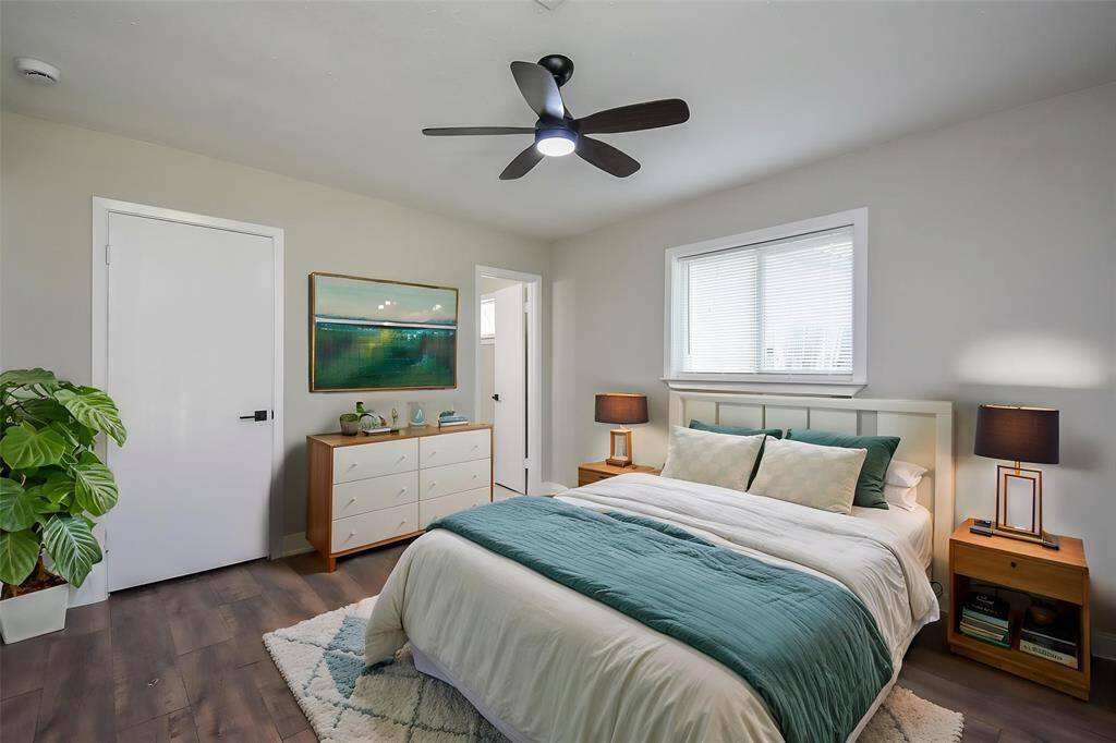 This spacious room has a wood-like flooring that flows throughout the room.