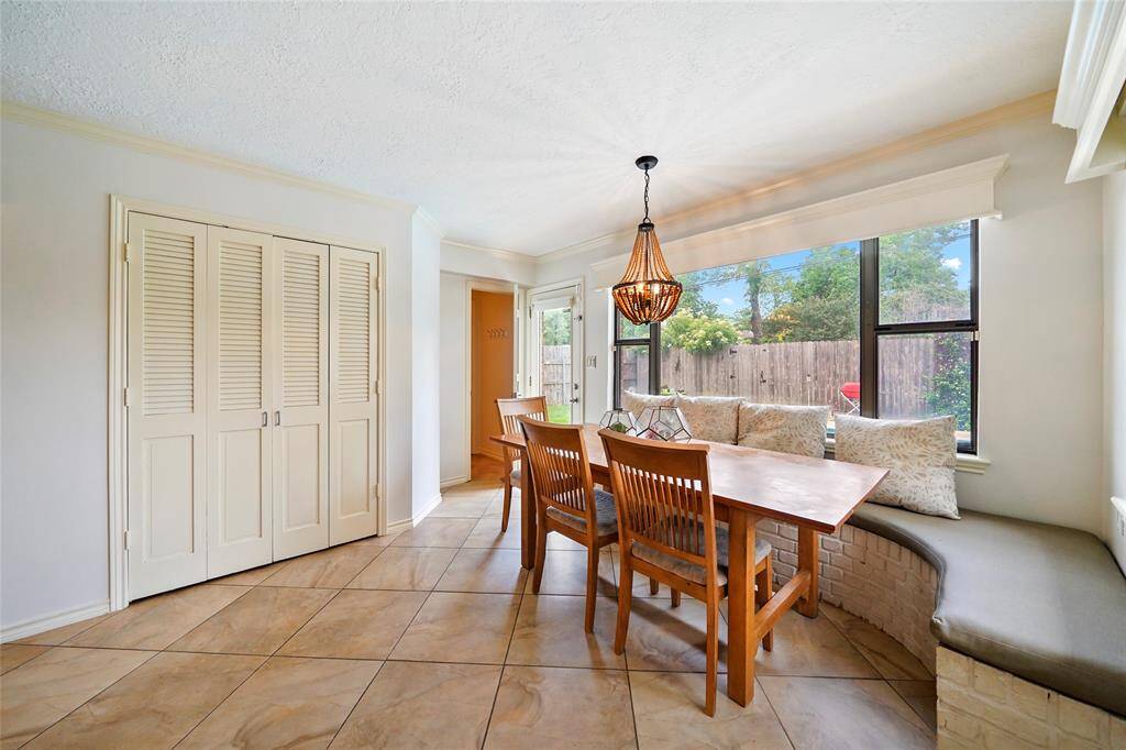 This built-in bench is perfect for entertaining and you can peek out into the backyard to see the glistening pool.  The doorway to your left leads to your half bath, a perfect location considering the pool is just steps away. Table can stay.