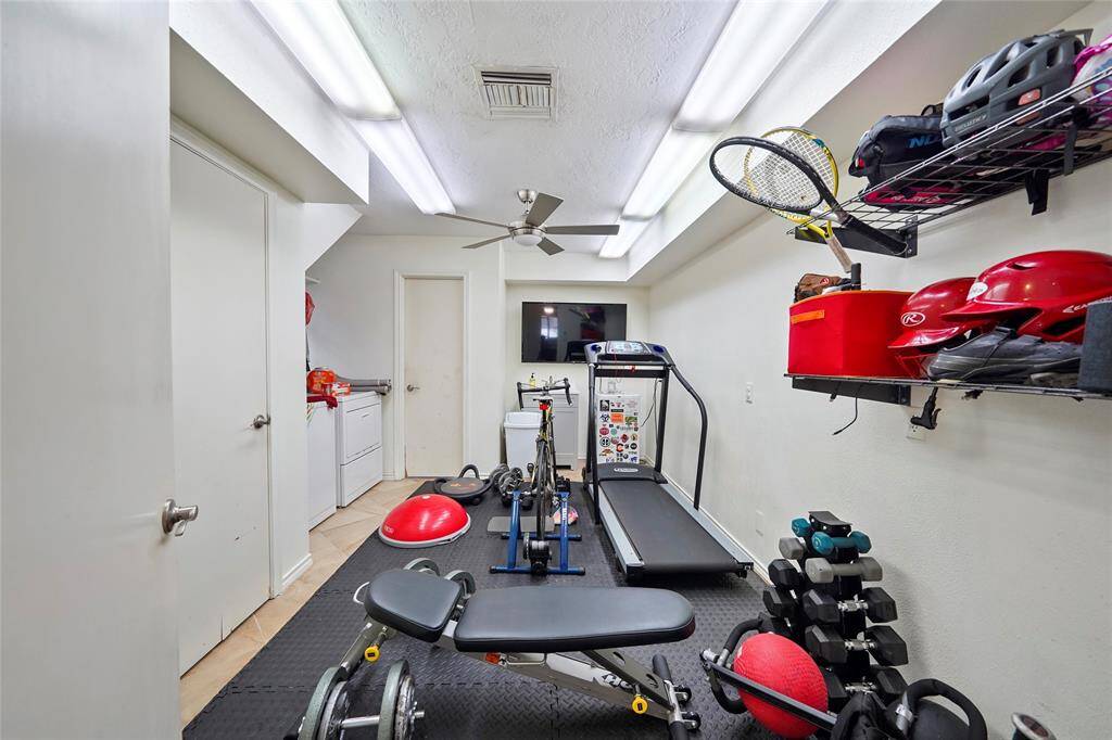 The huge mud room is centrally located next to the kitchen and features two closets and loads of space.  It is currently being used as a weight room.
