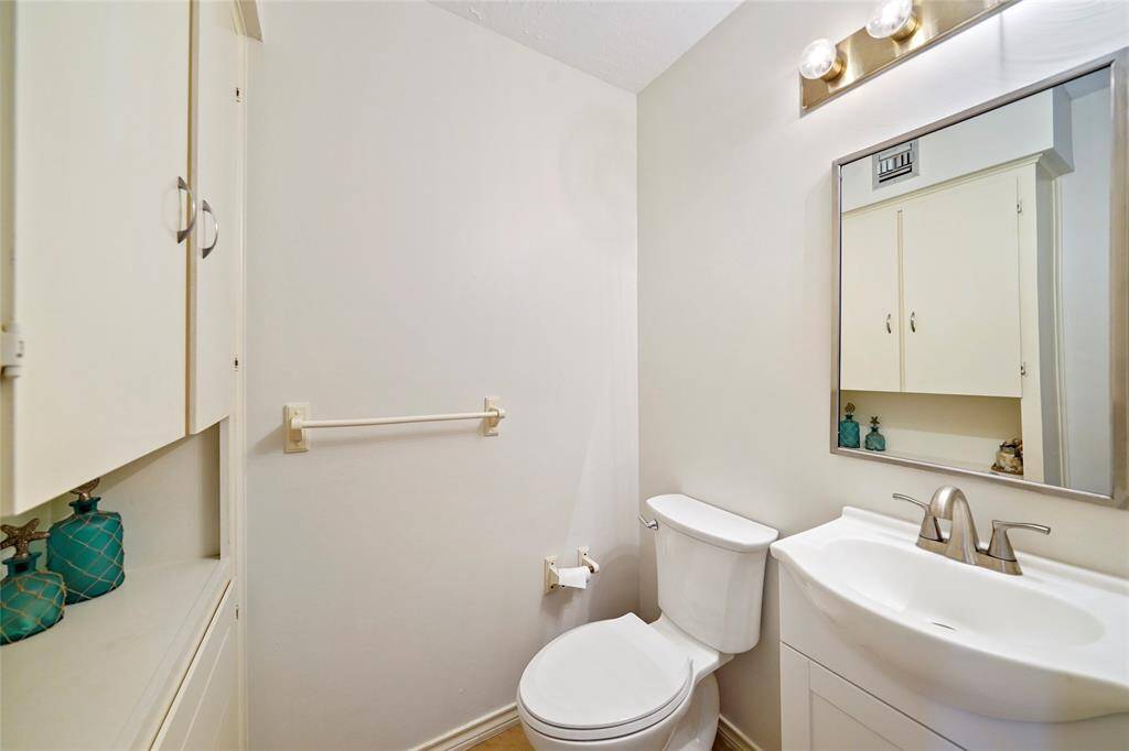 A view of the half bath on the first floor located in close proximity to the pool.