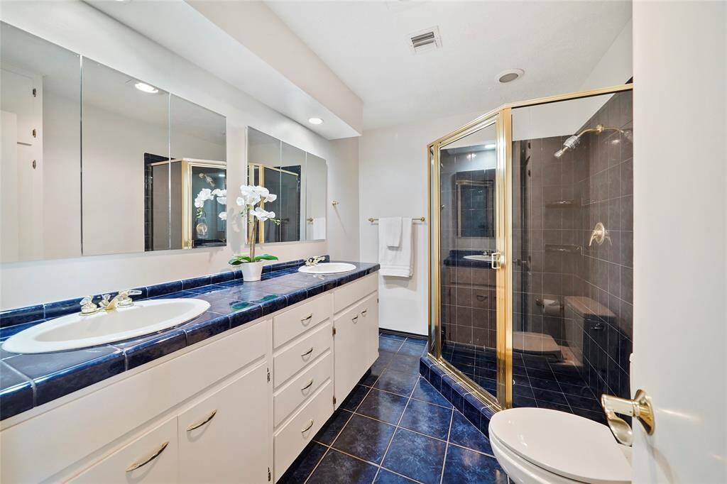 The full bathroom on the second floor features a large vanity with double sinks and walk-in shower.