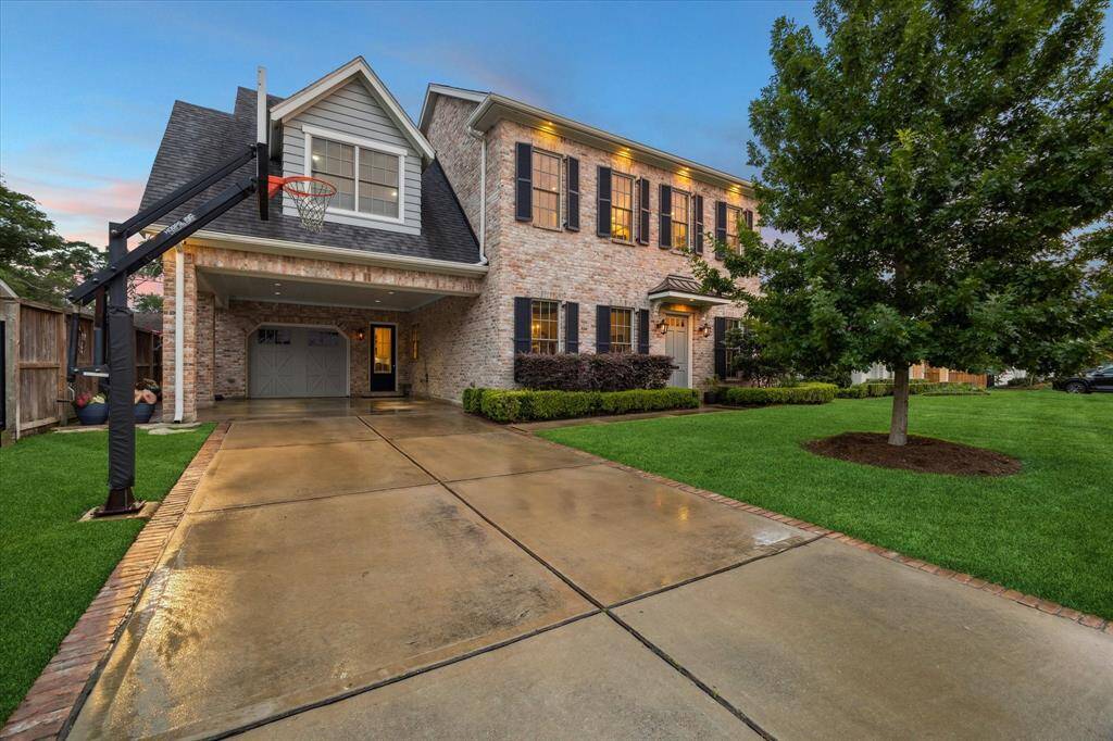 The home features a two-car porte-cochère and an oversized single-car garage, offering ample.