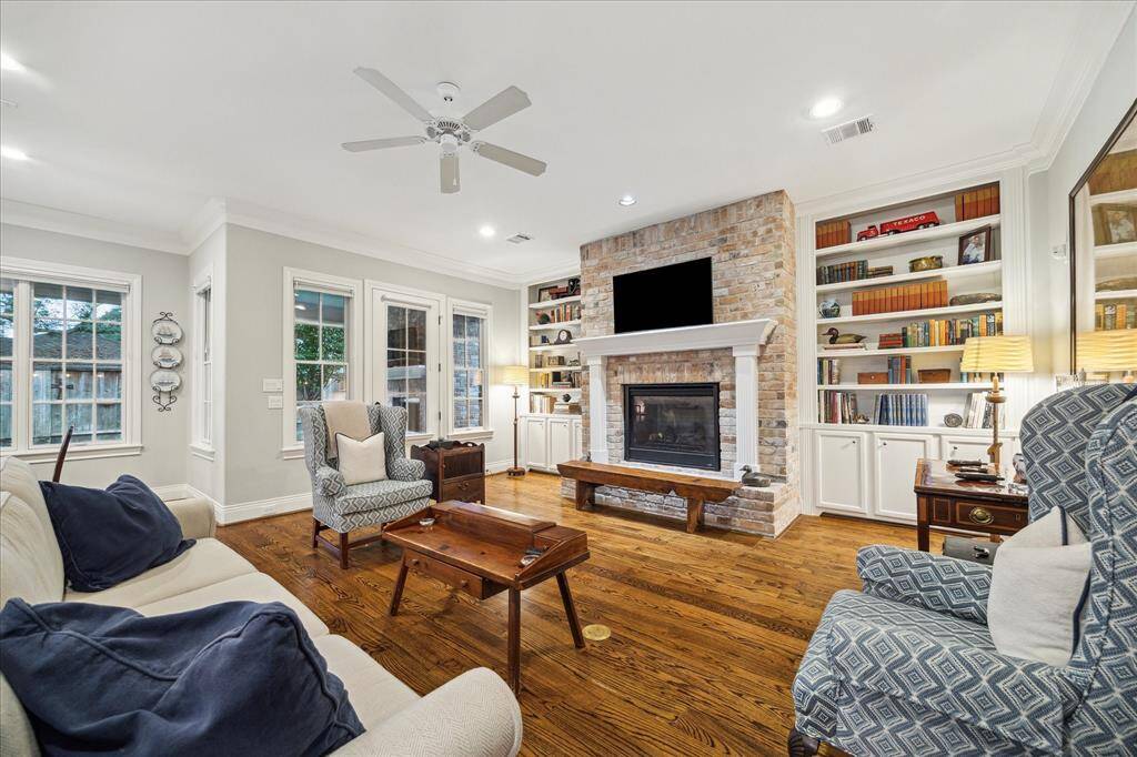 Large windows and elegant French door flood the family room with natural light, creating a bright and welcoming atmosphere.