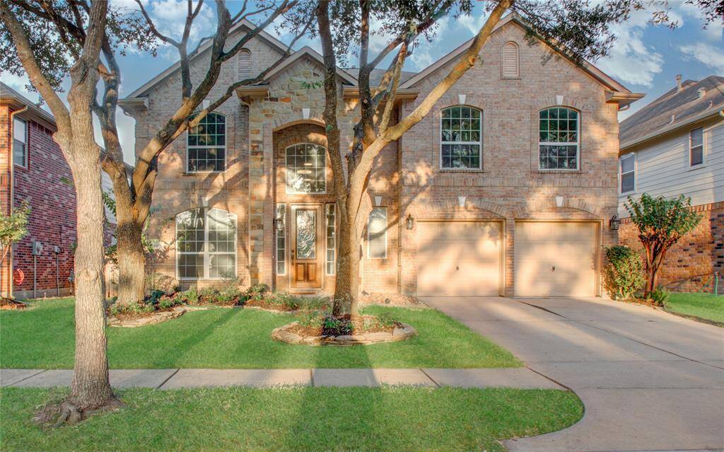 Charming two-story brick home with large windows and lots of lighting!