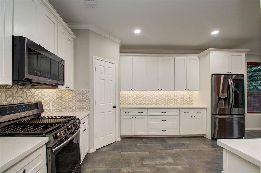 Kitchen is brightly lit with recessed lighting!